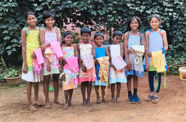 Girls receiving new dresses